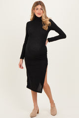 woman wearing a black ribbed maternity dress with long sleeves and a side slit, highlighting her baby bump
