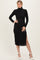 woman wearing a black ribbed turtleneck midi dress with long sleeves and a side slit