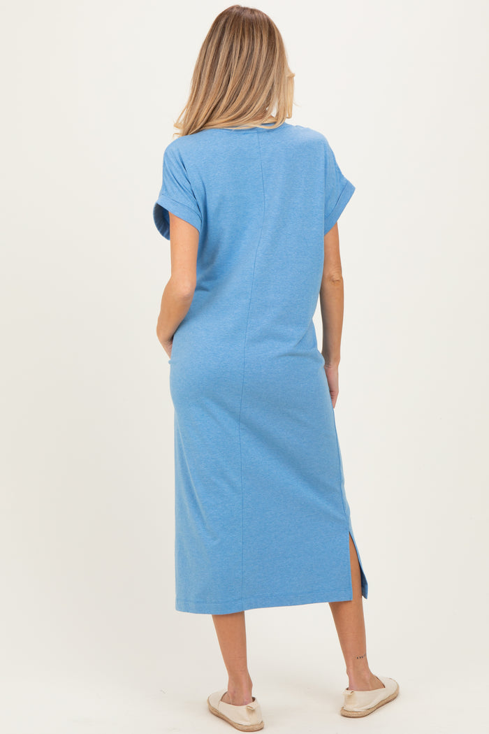 woman wearing a blue short sleeve maternity maxi dress with side slits, shown from the back