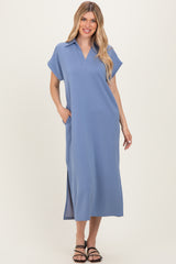 woman wearing a light blue short sleeve midi dress with a collar and side pockets