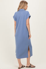 woman wearing a light blue short sleeve maxi dress with side slits, shown from the back