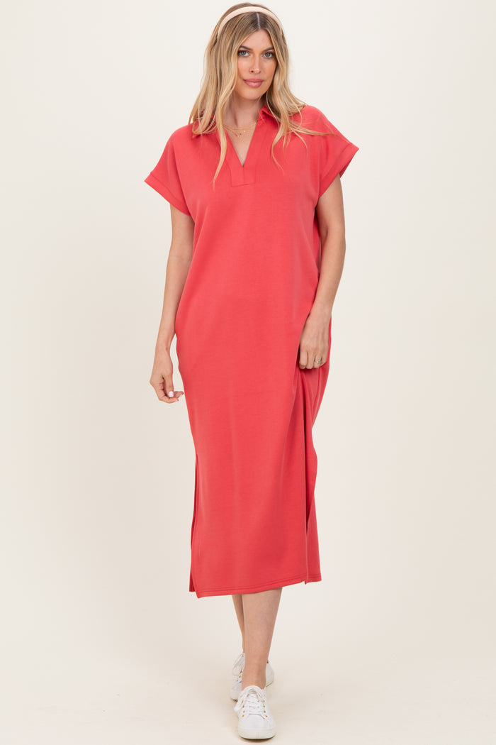woman wearing a coral midi dress with cap sleeves and a v-neckline, styled with white sneakers