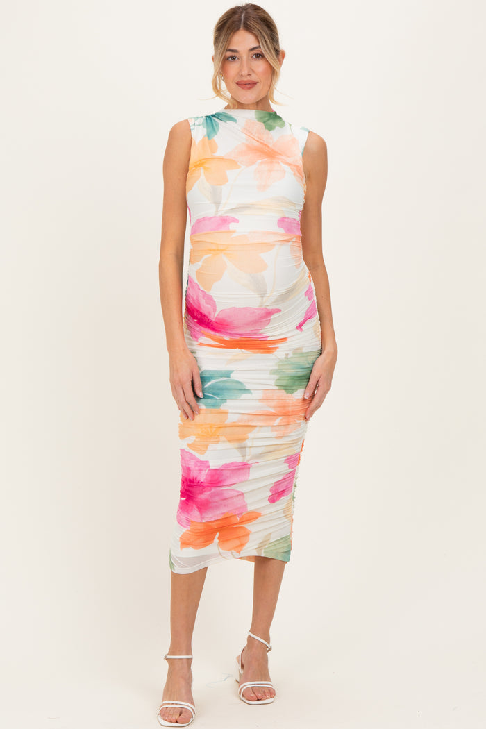 woman wearing a floral print maternity dress with a fitted silhouette and a visible baby bump