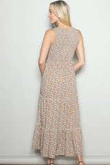 woman wearing a back view of a floral print sleeveless maxi dress with tiered ruffles
