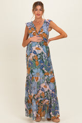 woman wearing a floral maternity maxi dress with ruffled sleeves and holding her baby bump
