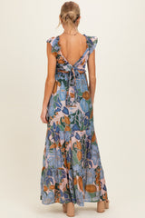 woman wearing a floral print maternity maxi dress with ruffled sleeves and tied back detail