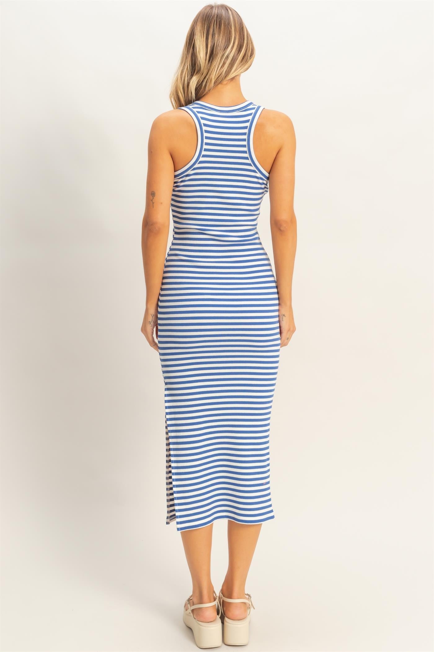woman wearing a blue and white striped sleeveless midi dress with a side slit