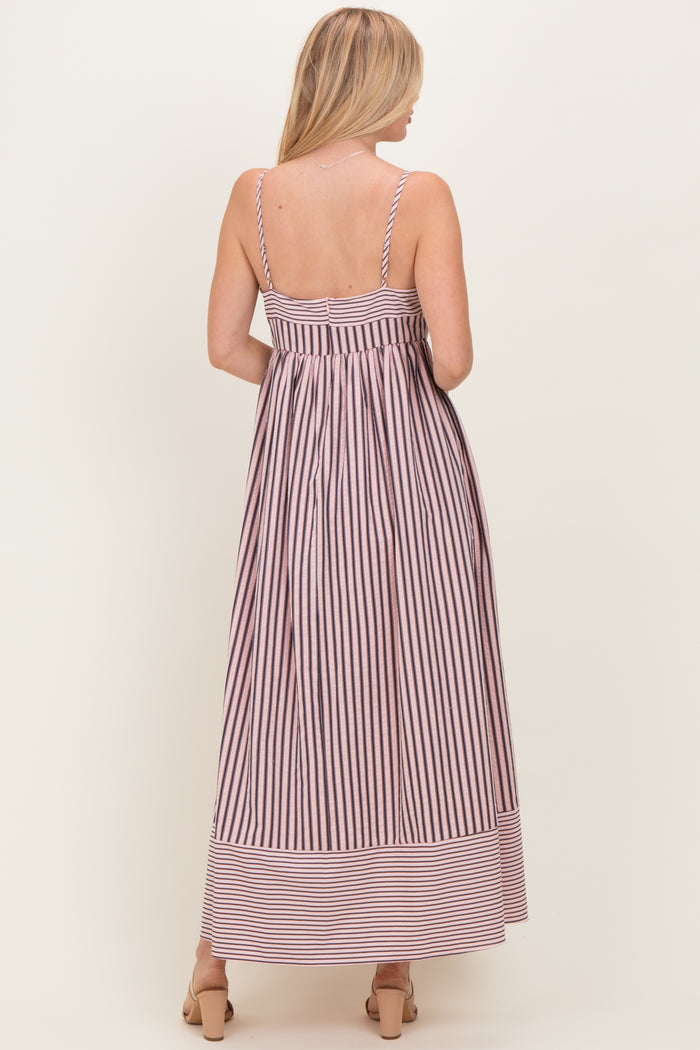 woman wearing a back view of a striped maxi dress with thin straps and a fitted bodice