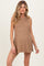 woman wearing a tan sleeveless maternity top with a ribbed texture and side slits