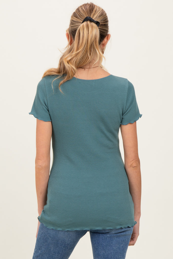 woman wearing a teal maternity top with short sleeves and scalloped hem, viewed from the back