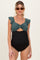 woman wearing a dark green maternity swimsuit with ruffle straps and a tied front, showcasing her baby bump