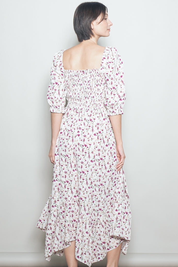 woman wearing a white floral midi dress with puff sleeves and a smocked back detail
