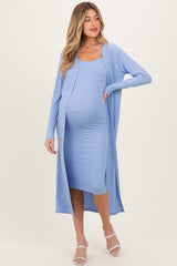 woman wearing a light blue ribbed maternity dress with a long cardigan and visible baby bump