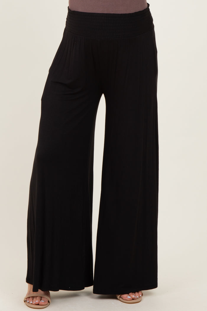 maternity wear black wide-leg pants with a smocked waistband, model not visible.