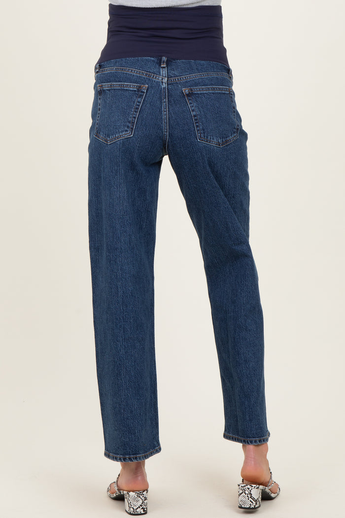woman wearing maternity blue jeans with a supportive belly band, standing with her back to the camera