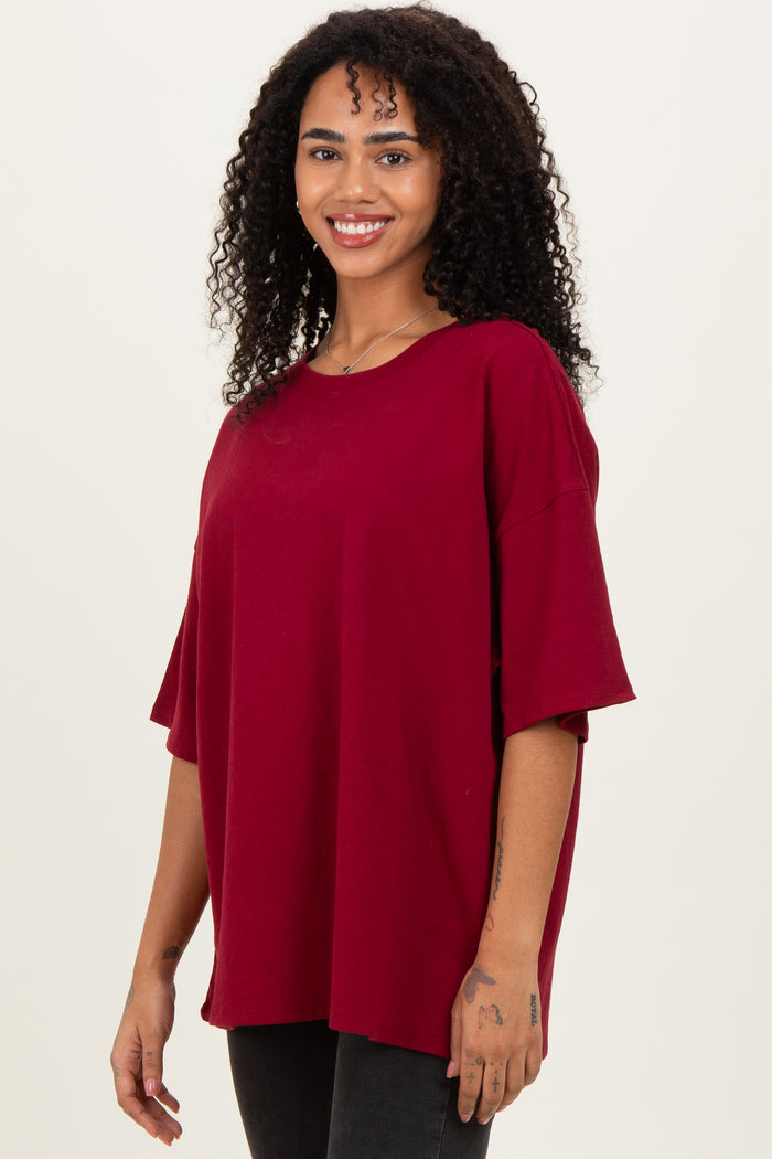 woman wearing a burgundy oversized t-shirt with short sleeves and a relaxed fit