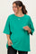 woman wearing a bright green oversized maternity t-shirt and showing her baby bump