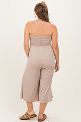 woman wearing a taupe strapless maternity jumpsuit with a relaxed fit and cropped legs