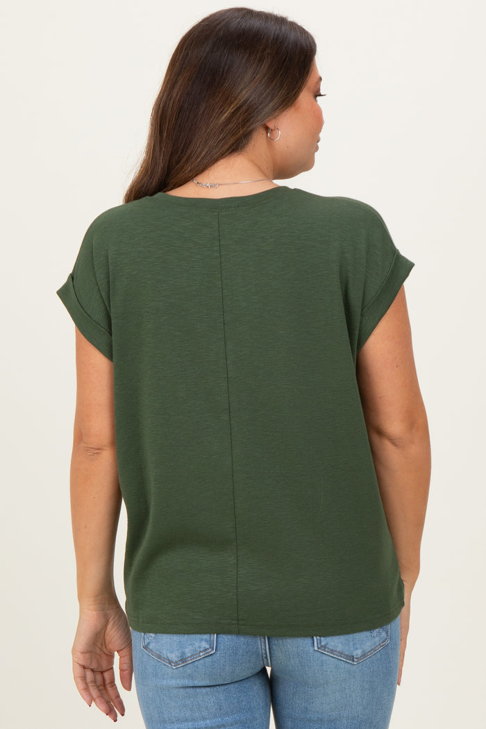 woman wearing a dark green maternity top with rolled sleeves viewed from the back, paired with light blue jeans