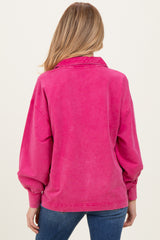 woman wearing a pink oversized maternity sweatshirt with a collared neckline and balloon sleeves, viewed from the back