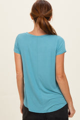 woman wearing a teal short sleeve top with a curved hem and a relaxed fit, viewed from the back