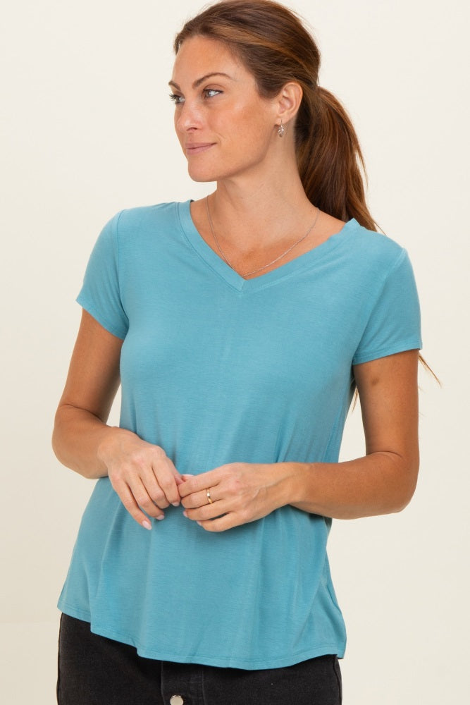 woman wearing a teal v-neck short sleeve t-shirt with a relaxed fit and a slight flare at the hem