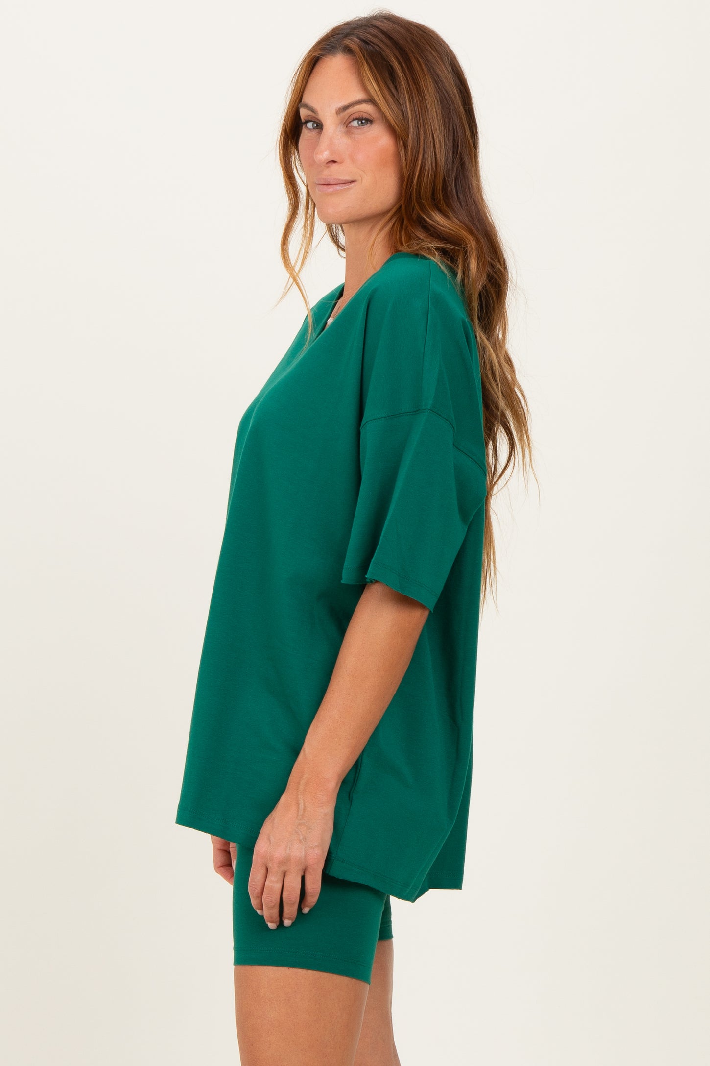 woman wearing a relaxed fit green oversized t-shirt and matching green biker shorts