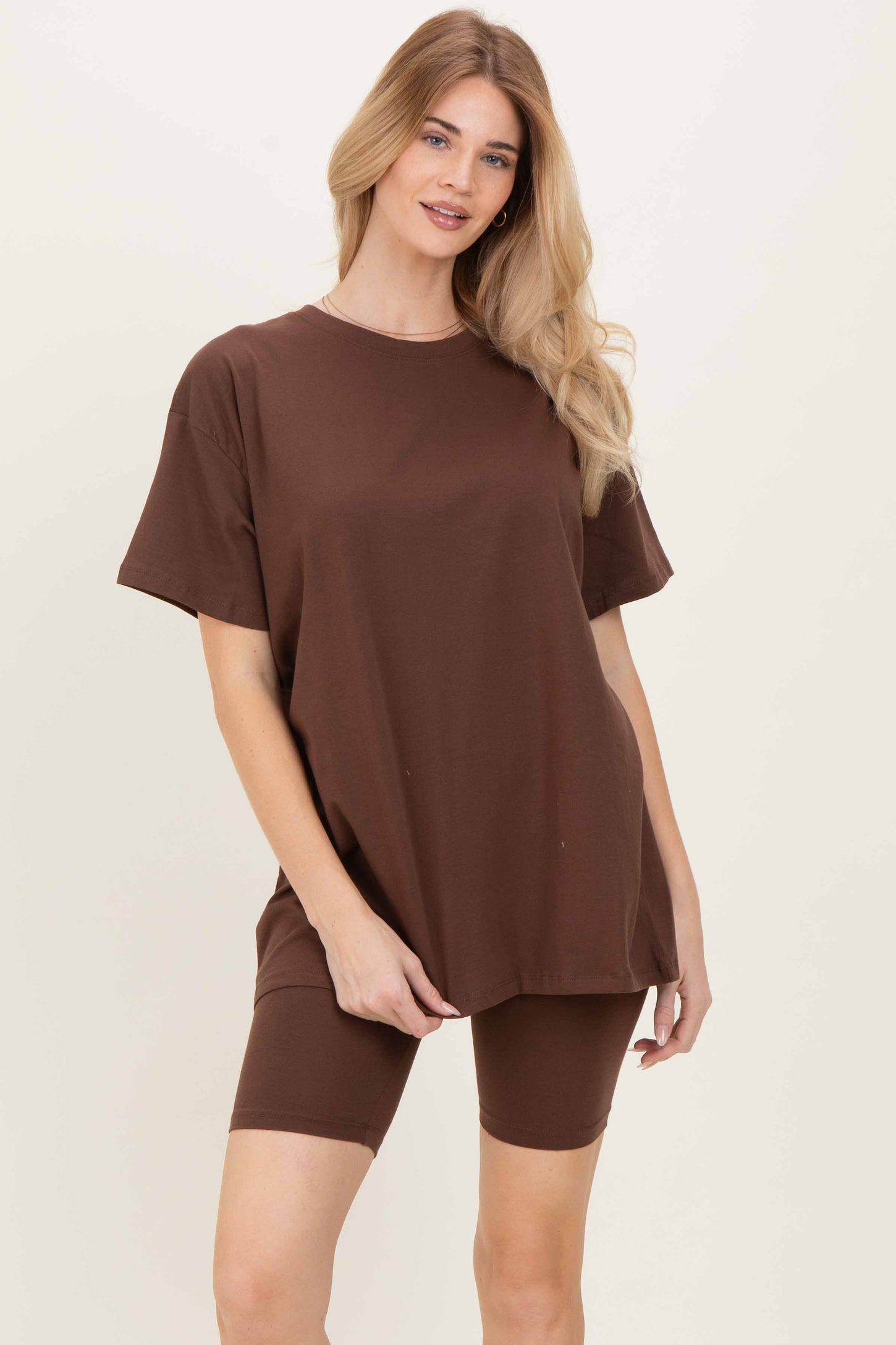 woman wearing a brown oversized t-shirt with matching fitted bike shorts