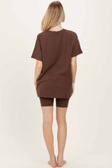 woman wearing a loose brown oversized t-shirt and matching brown shorts, viewed from the back