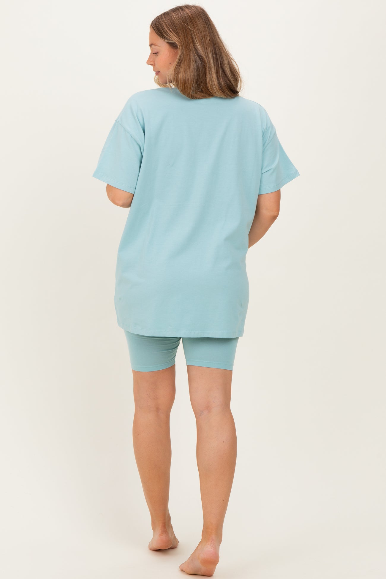 woman wearing a light blue maternity loungewear set featuring a loose t-shirt and matching shorts