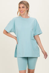 woman wearing a light blue oversized t-shirt and matching bike shorts
