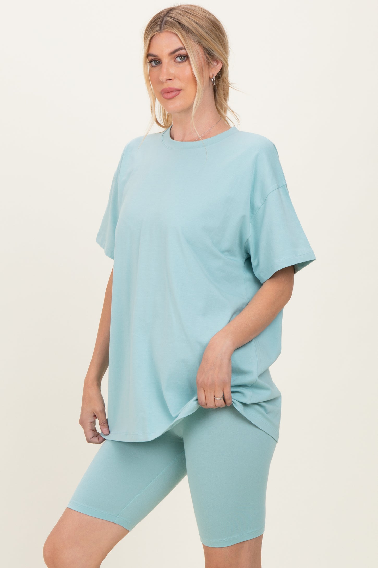 woman wearing a light blue oversized t-shirt and matching bike shorts