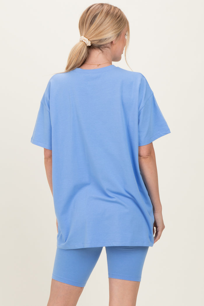 woman wearing a light blue oversized t-shirt and matching bike shorts, seen from the back