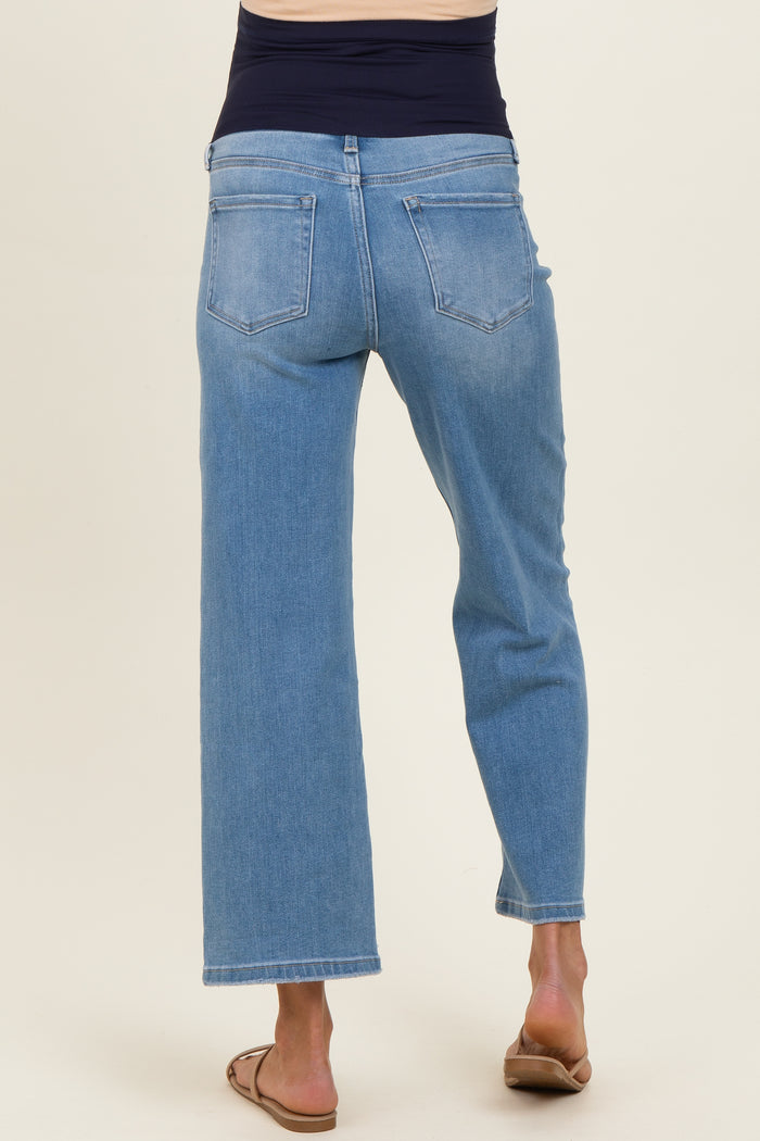 woman wearing light blue maternity wide-leg jeans, showing the back view and not displaying a baby bump