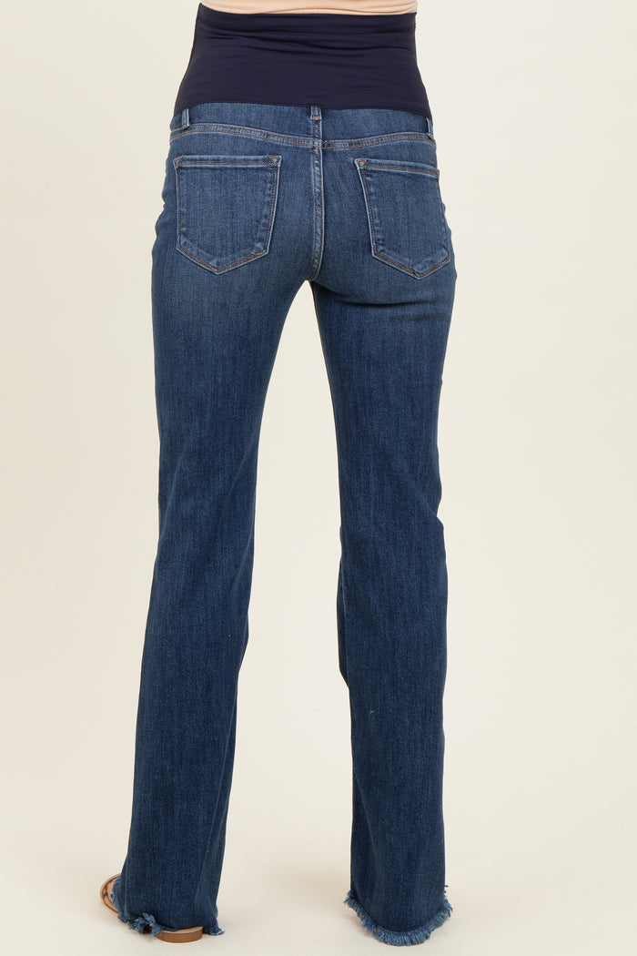 woman wearing dark blue maternity jeans with a stretchy waistband and frayed hem, showing the back view
