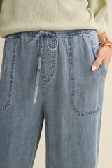 woman wearing light blue drawstring wide-leg pants with side pockets and a comfortable fit