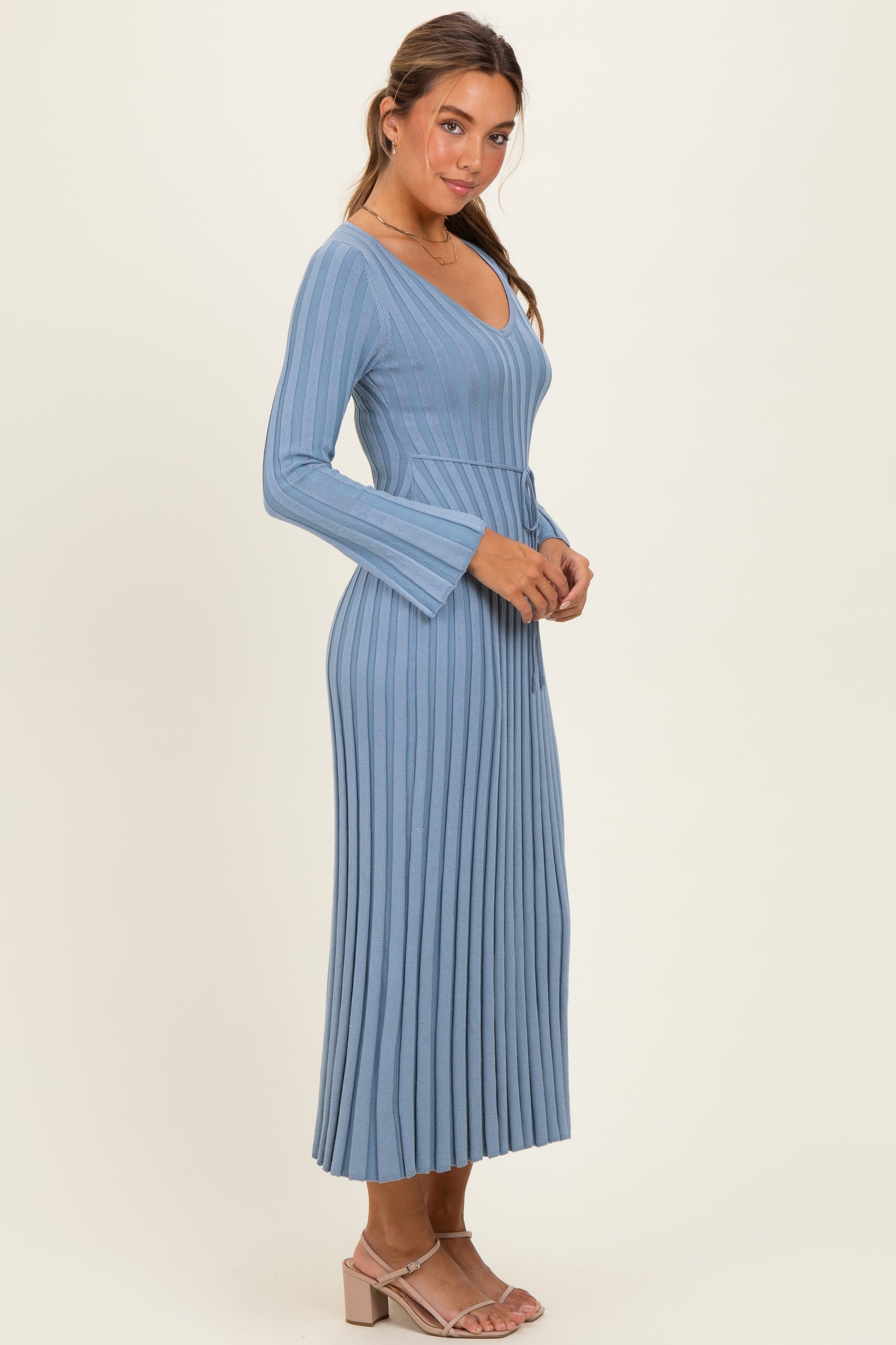 woman wearing a blue ribbed long sleeve maxi dress with a v-neck and belted waist