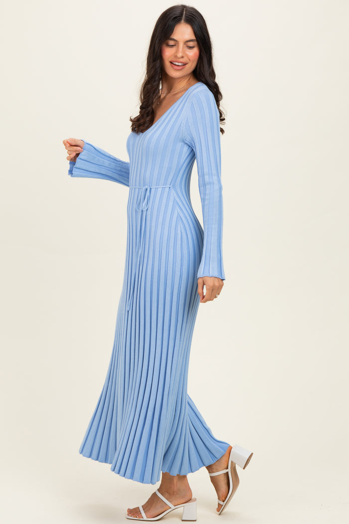 woman wearing a light blue long sleeve ribbed maxi dress with a v-neck and tie waist detail