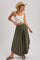 woman wearing an olive green maxi skirt and a white cropped tank top, styled with a straw hat and sandals