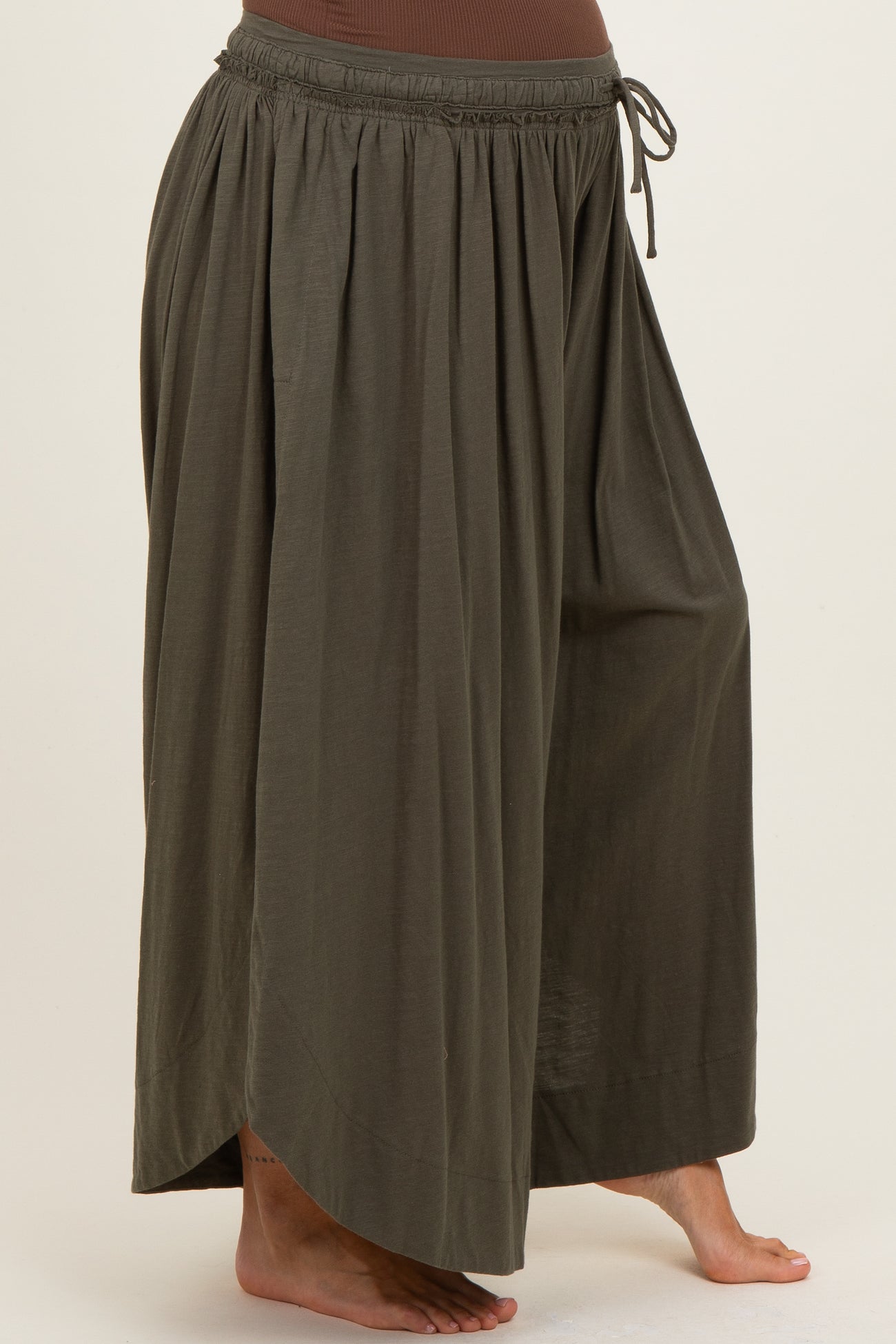 maternity wear in olive green flowy wide-leg pants with an elastic waistband and drawstring detailing