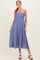 woman wearing a blue and white striped strapless maternity dress with an empire waist and flowing skirt