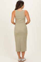 woman wearing a light green sleeveless maternity dress that falls to mid-calf, viewed from the back