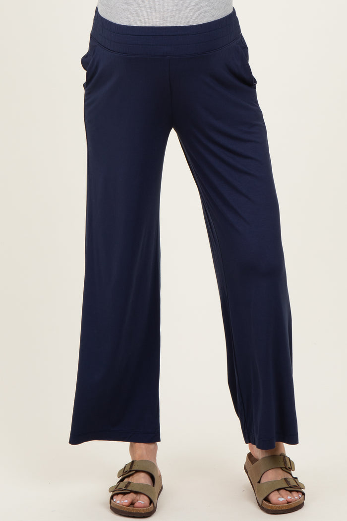 woman wearing navy blue maternity wide-leg pants with side pockets and a stretchy waistband