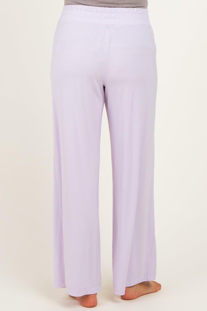 woman wearing light purple maternity wide-leg pants seen from the back