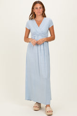 woman wearing a light blue short sleeve maxi dress with a v-neck and gathered waist detail