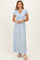 woman wearing a light blue short sleeve maxi dress with a v-neck and gathered waist detail