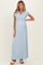 woman wearing a light blue maternity maxi dress with a wrapped bodice and short sleeves, showing her baby bump