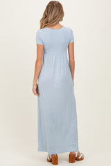 woman wearing a light blue short sleeve maternity maxi dress with a gathered waist and sandals