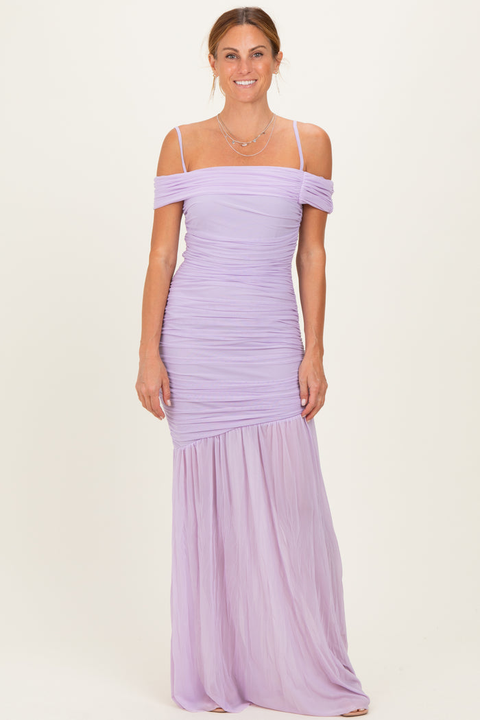 woman wearing a lavender off-the-shoulder ruched maxi dress with a flowing lower skirt