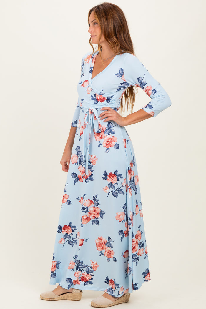 woman wearing a light blue floral maxi dress with long sleeves and a wrap design